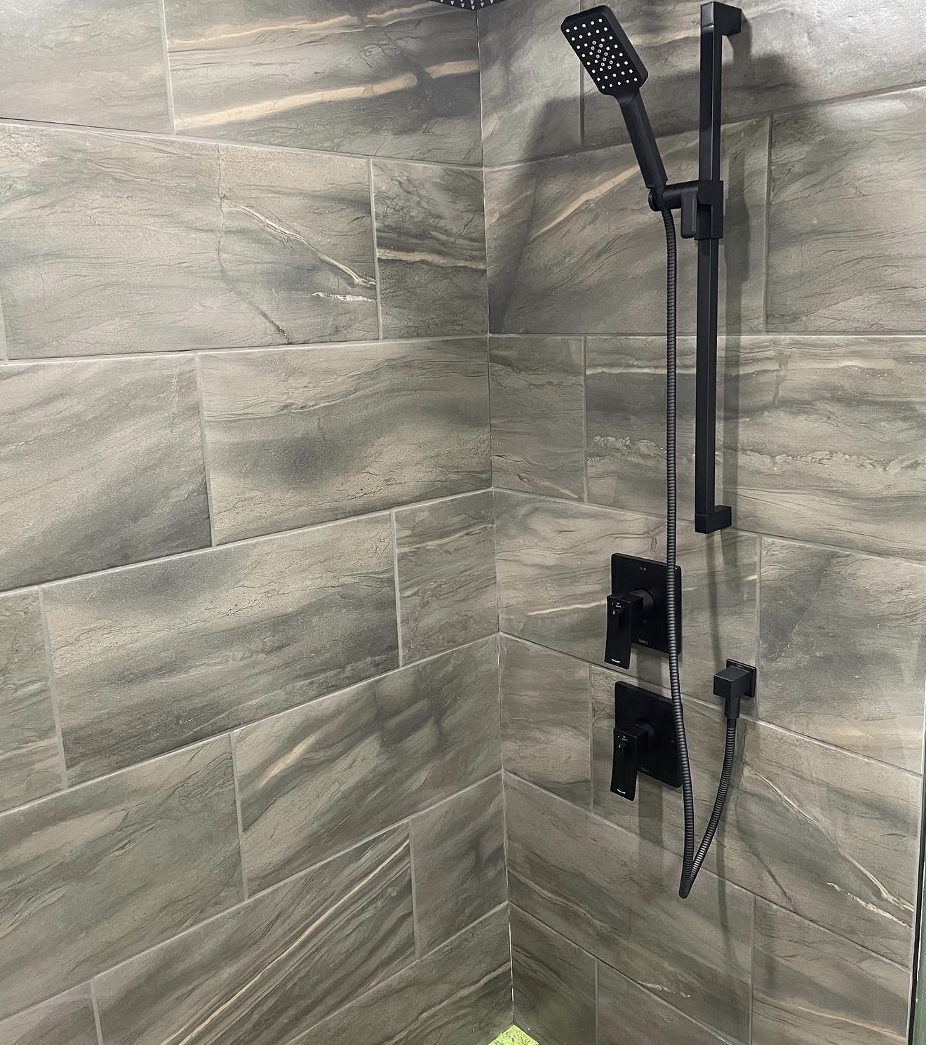 Finished tile shower with black plumbing fixtures