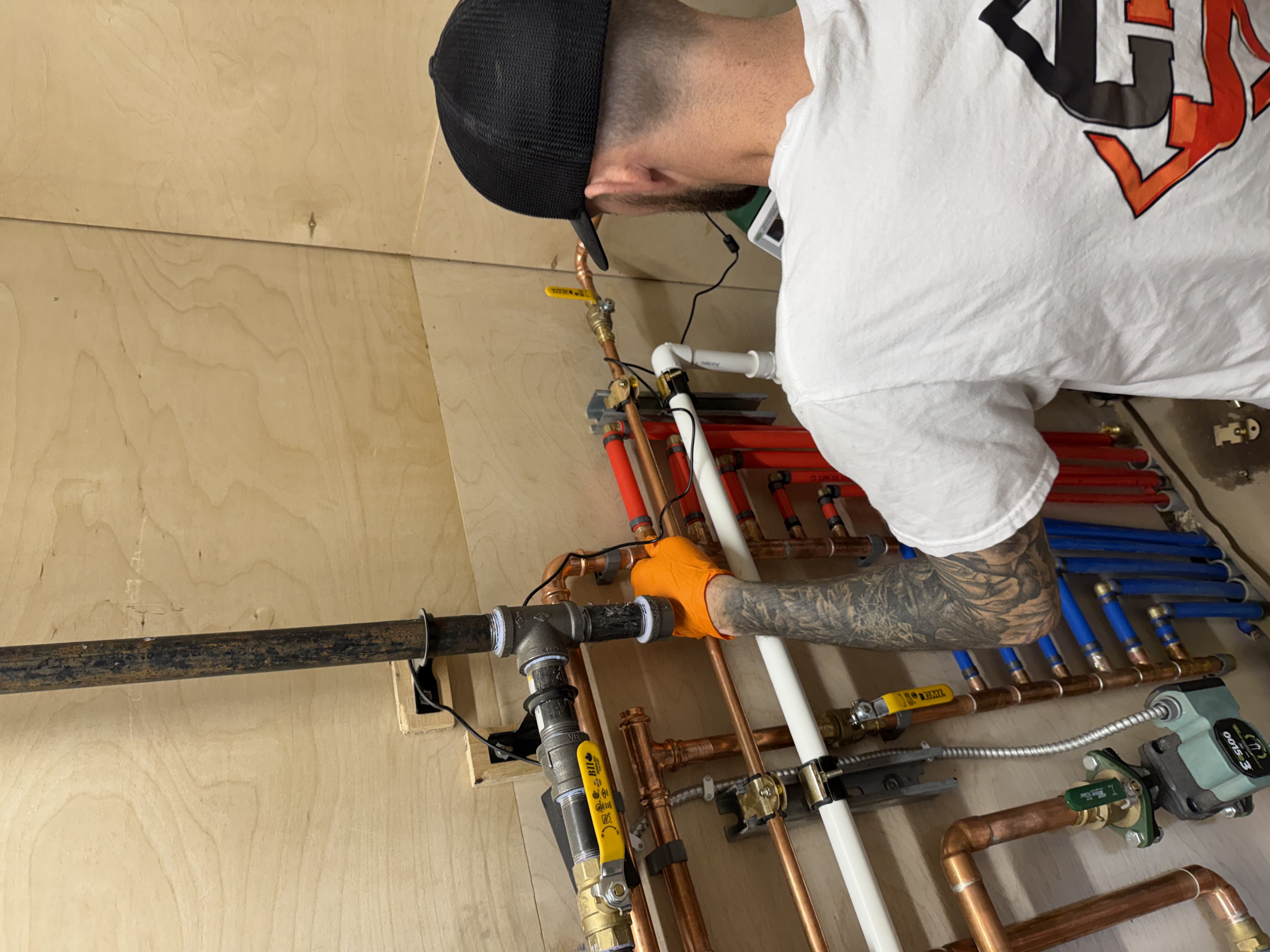Dylan Seabrook working on plumbing installation and piping connections